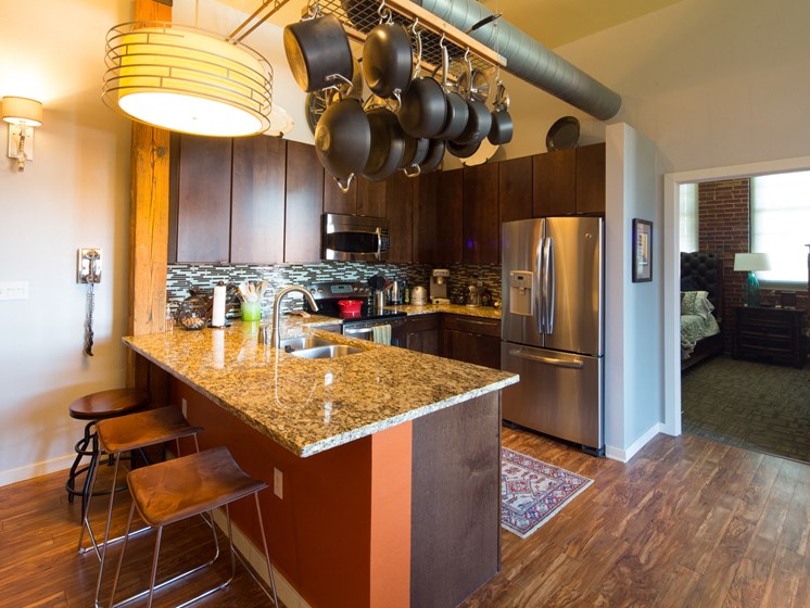 view of kitchen, equipped with stainless steel appliances and counter seating